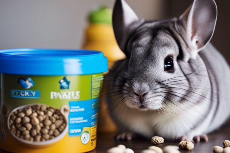 A close-up image of a chinchilla next to a container of PAKILS pet food, with some of the food pellets scattered around. The chinchilla has grey and white fur, large ears, and bright eyes. The container is blue and green and has an image of a chinchilla on the label. The image conveys a sense of curiosity and appetite.